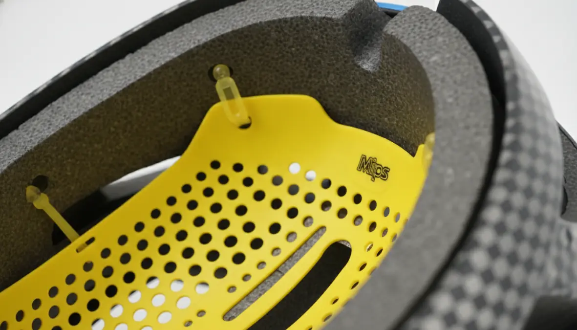 MIPS slip-plane technology showing yellow rotational protection liner inside cycling helmet